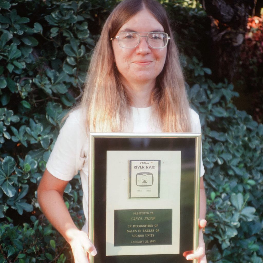 Female game designer Carol Shaw holding an award for her game River Raid.