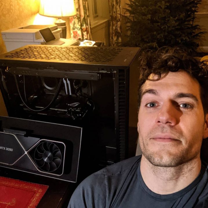A photo of Henry Cavill in front of the gaming PC he built.