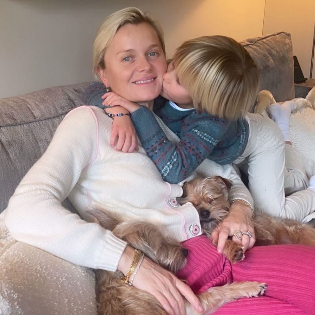 Dr. Barbara Sturm lounges on the couch with her to dogs and son Pepper Sturm