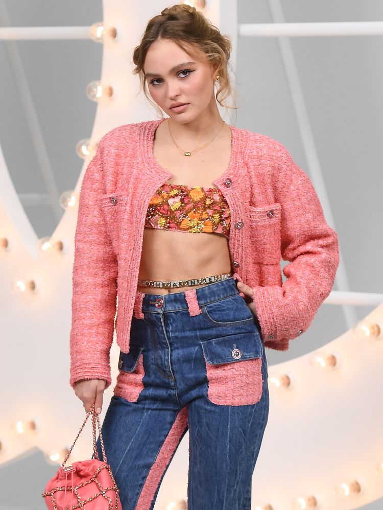 Lily Rose-Depp rocking  with a bandeau top and Chanel brocade jacket and jeans. 