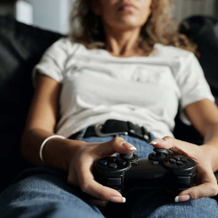 Girl lounging playing video games on controller